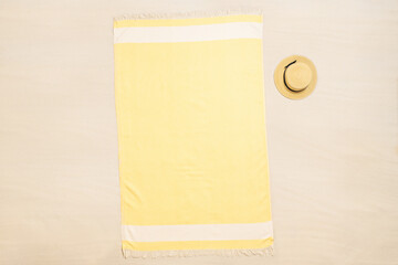 Yellow towel with straw hat on tropical sand beach. Top and aerial view. Ocean coastline. Drone photo. Background - 434545782