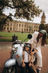 scooter riding mom and daughter in the park