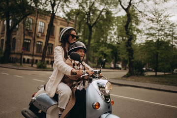 scooter riding mom and daughter in the park © Elizaveta Kovalevska