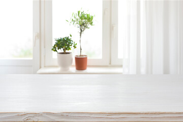 Wood texture table on blurred window sill with houseplants background