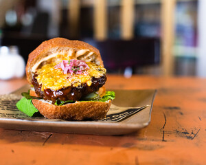 Cheeseburger on brown plate
