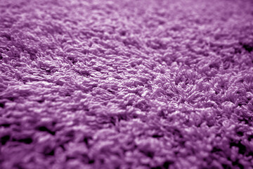 Fototapeta na wymiar Bath towel texture with blur effect in purple color.