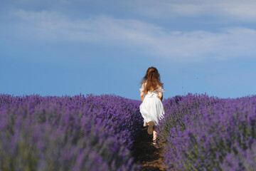 running girl in white dress in lavender