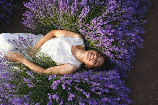 laughing woman laying in lavender