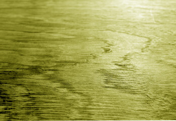 Old oak board texture as background with blur effect in yellow tone.