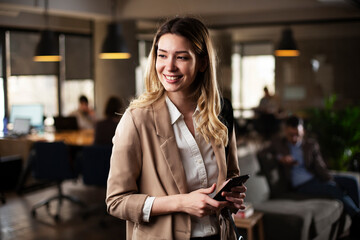 Businesswoman in office. Smiling businesswoman using the phone.