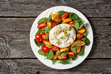 Spinach, Tomato and Burrata Salad on a plate