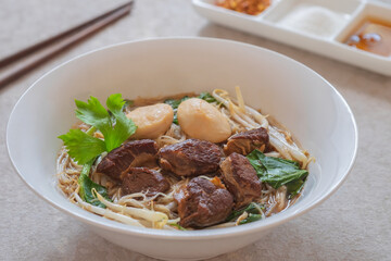 Noodle soup with braised pork and pork balls in bowl, Thai food style
