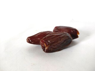selectively focus on dates fruit (Phoenix dactylifera) isolated on a white background. fasting food