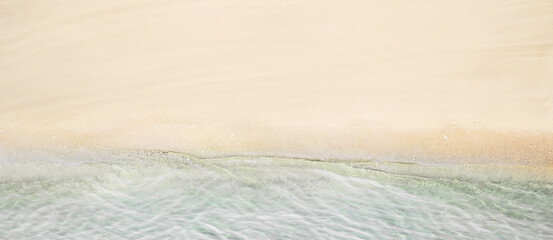 Fototapeta na wymiar Top and aerial view on tropical sand beach with sea. Ocean coastline. Drone photo. Background. Panorama, 16:9