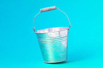 Metal bucket  on the blue background