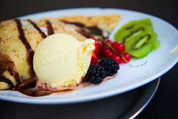 Fresh fruits mix with vanilla ice cream and crepe.