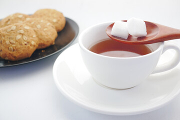 cup of tea and sugar cube on table