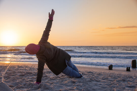 Exercises at sunset by the Baltic Sea near the city of Kolobrzeg 