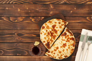 Baked homemade flatbread on wooden background close up