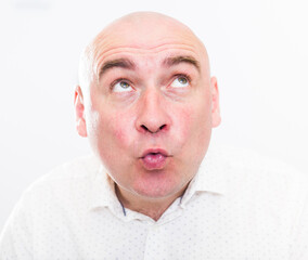portrait of bald adult mature man with emotions on white background