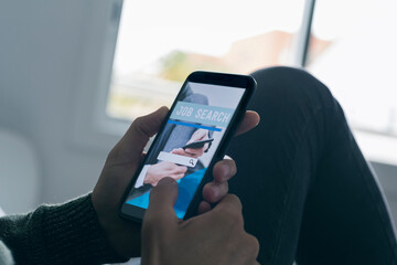 man searching job with his smartphone