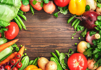 Healthy food. Assortment of fresh summer organic vegetables and herbs on wooden table background