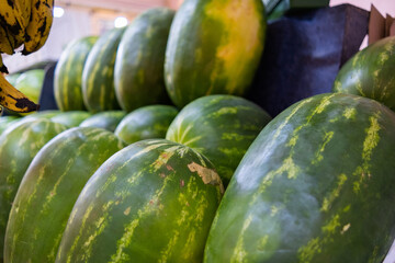 Fresh and juicy-looking watermelons on a fruit stand