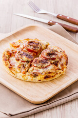 Mini pizza with sausage and cheese
