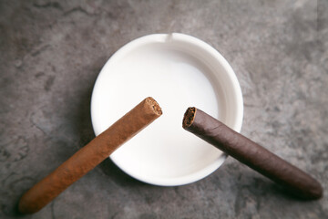  Cigar and ashtray on table. Smoking