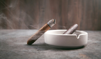  Cigar and ashtray on table. Smoking