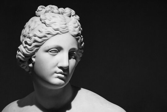 Black and white photo in close-up on young girl face of ancient roman sculpture