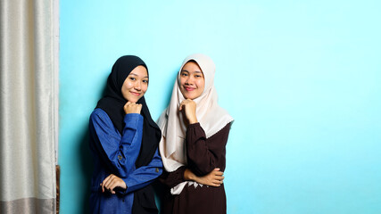 Portrait of young beautiful woman on blue background with ornamental curtain