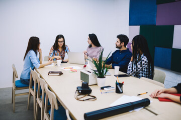 Woman explaining plan for coworkers in office