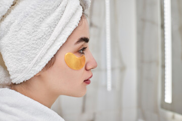 beautiful woman with eye patches in white bathrobes in bathroom