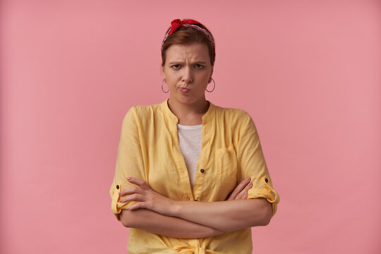 Image european brown haired woman wearing stylish outfit white t-shirt and yellow shirt and red bandana posing against pink background emotion annoyed bored irritation looking at you arms crossed