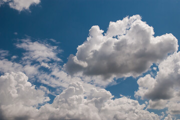 Naklejka na ściany i meble beautiful background with volumetric clouds on the blue sky