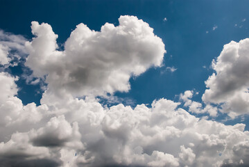 beautiful background with volumetric clouds on the blue sky