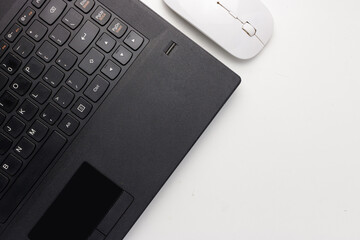 Flat lay, top view black laptop and white mouse on white office desk with copy space, workspace blank. Minimal desk concept. 2