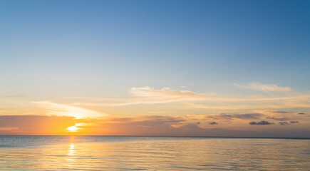 sunset sky over sea in the evening with colorful orange sunlight sundown 