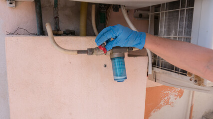 cleaning and disassembly and filling of a boiler anti-limescale dosing filter 