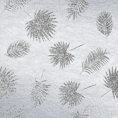 Silver leather background with glitter tropical leaves pattern. Sparkle material backdrop. Shine paper