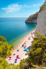 View of famous Baia delle Zagare (Zagare Bay) or Baia dei Mergoli (Mergoli Bay) with colorful beach...