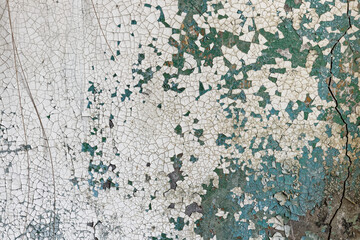 Cracked paint on cracked concrete wall
