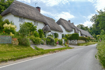 Fototapeta na wymiar Thatched Cottages In Stapleford, Wiltshire, England
