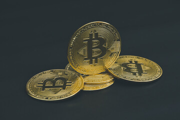 Bitcoin coins laid out on a black background.