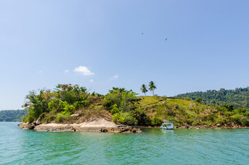 Coastline scenic view with blue sky and sea. Summer vacation day at Paraty's sea.