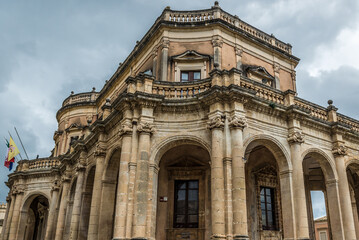 Fototapeta na wymiar Side view of Palazzo Ducezio building in center of historic part of Noto city, Sicily in Italy