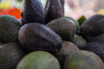 Pile of fresh avocados with blurry background