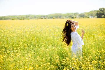 Young woman in the rapeseed field