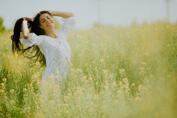 Young woman in the rapeseed field
