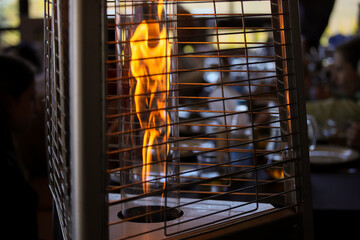 A closeup selective focus shot of an outdoor heater. 