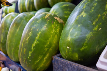 Fresh and juicy-looking watermelons on a fruit stand