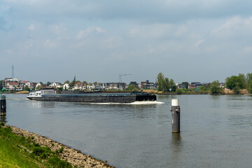 river barge transporting goods on the Noord canal in South Holland