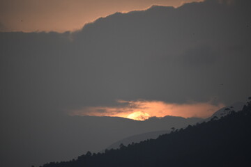 A view of sun setting behind the hills of munnar